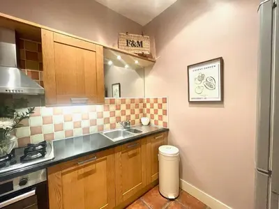 a kitchen with a sink and a counter top at Glasgow City - Large Stylish 2 Bed Flat in Unique Ibrox Location Walking Distance to Subway and Free On-Street Parking in Glasgow