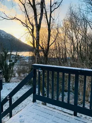 a wooden bench with snow on the ground at Mountain View Self Catering Ballachulish Glencoe in North Ballachulish