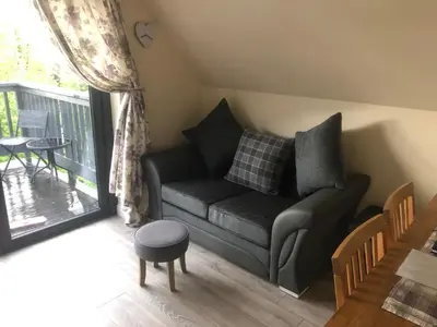 a living room with a couch and a table at Mountain View Self Catering Ballachulish Glencoe in North Ballachulish
