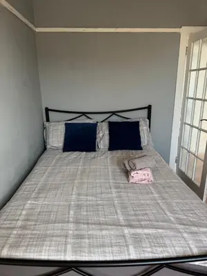 a bed with a blanket and pillows in a room at City break in Edinburgh
