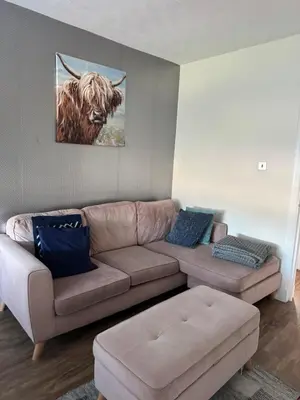 a living room with a couch and a picture of a bull at City break in Edinburgh