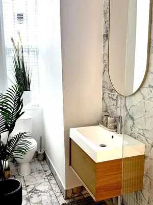 a bathroom with a sink and a mirror at Castlegreen Lux Apartment in Dumbarton