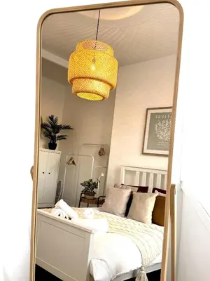 a mirror reflection of a bed in a bedroom at Castlegreen Lux Apartment in Dumbarton