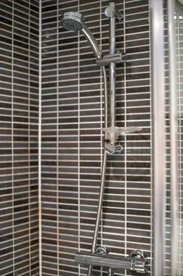 a shower with a shower head in a bathroom at Stylish Studio Finnieston City Centre Free Parking in Glasgow