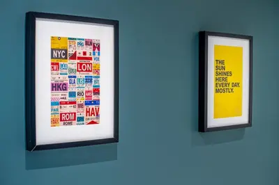 two framed posters on a wall in a room at Stylish Studio Finnieston City Centre Free Parking in Glasgow