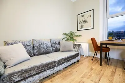 a living room with a couch and a table at Cosy City Centre Gem in Edinburgh