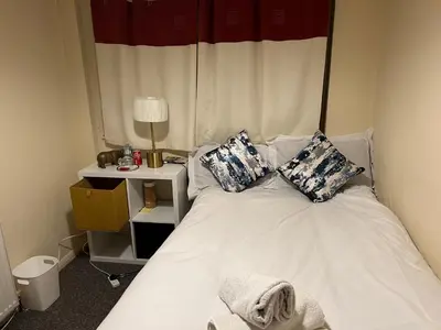 a bedroom with a white bed with pillows on it at IFYLOVESITt2 in Moffat