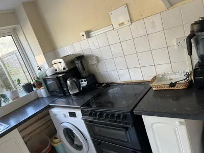 a kitchen with a stove and a washing machine at IFYLOVESITt2 in Moffat