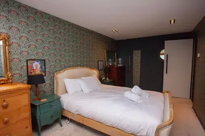 a bedroom with a bed with two pillows on it at Unique House in Park District in Glasgow