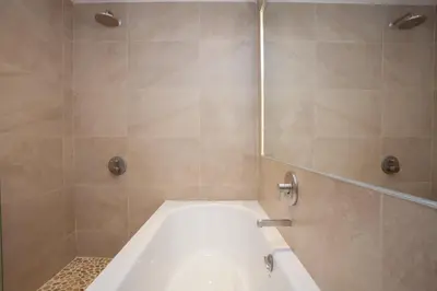 a bathroom with a bath tub and a shower at Unique House in Park District in Glasgow