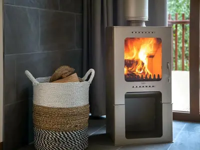 a wood fired oven with two baskets next to it at Strathyre, Ben Ledi Cabins - Forest Holidays in Callander