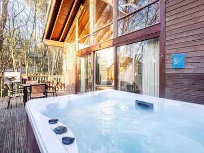 a large tub in front of a house at Strathyre, Ben Ledi Cabins - Forest Holidays in Callander