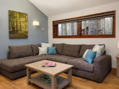 a living room with a couch and a table at Strathyre, Ben Ledi Cabins - Forest Holidays in Callander