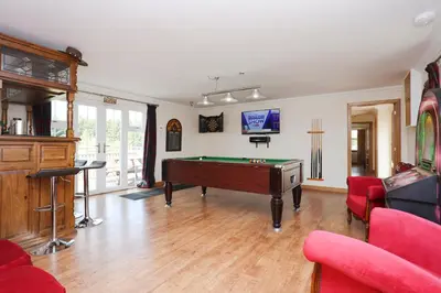 a living room with a pool table in it at JOIVY Greenknowes Farmhouse with Hot Tub and Bar in Kelty