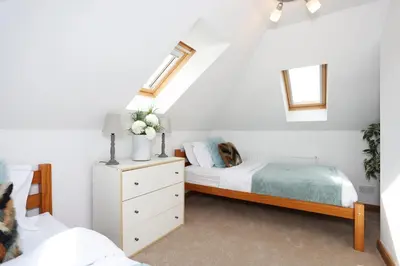 a bedroom with a bed and a dresser with a bed sqor at JOIVY Greenknowes Estate with Hot Tub and Bar - Farmhouse and Lodge in Kelty