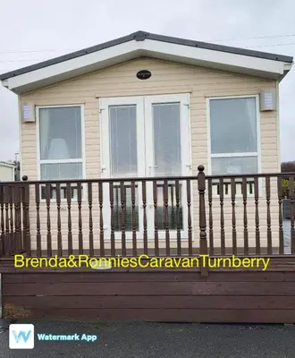 a small house with a fence and windows at B&R 18 Gleneagles in Turnberry