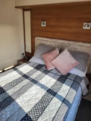 a bedroom with a bed with two pillows on it at B&R 18 Gleneagles in Turnberry