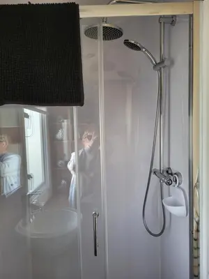 a person standing in a shower in a bathroom at B&R 18 Gleneagles in Turnberry