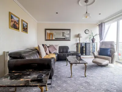 a living room with a couch and a table at Metropolitan St Andrews Cathedral View - Pass the Keys in Glasgow