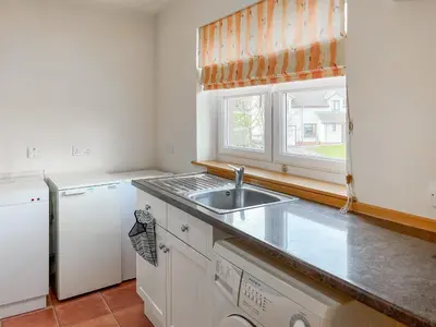 a kitchen with a sink and a white refrigerator at Norwood in Thornhill