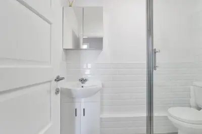 a white bathroom with a sink and a toilet at Alloa City Centre in Alloa