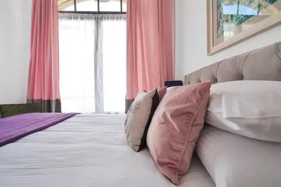 a bedroom with a bed with pillows on it at Alloa City Centre in Alloa