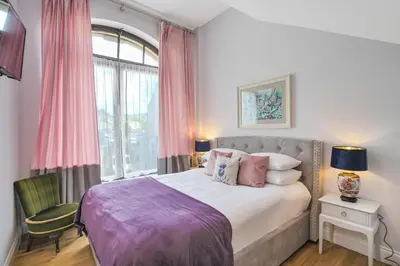 a bedroom with a large bed and a window at Alloa City Centre in Alloa