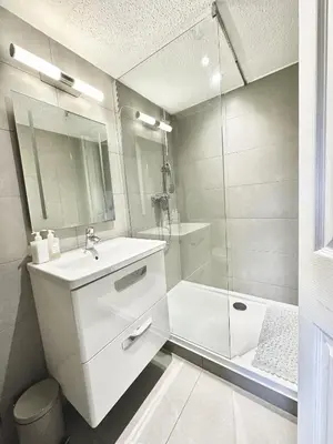 a white bathroom with a sink and a shower at Cherry Trees in Inveraray