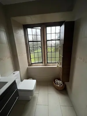 a bathroom with a toilet and a window at Lovely Carlung House in West Kilbride
