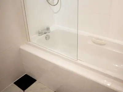 a white bath tub with a glass shower door at Perfect Location in Heart of Glasgow West End - Pass the Keys in Glasgow