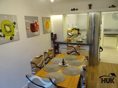 a dining room with a wooden table and chairs at Modern Oasis , Edinburgh Airport near,8mi in Rosyth