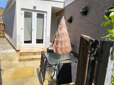 a glass table with a christmas tree on a patio at Modern Oasis , Edinburgh Airport near,8mi in Rosyth