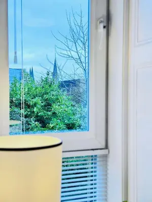 a window with a view of a church at Elegant City Centre Apartment in Edinburgh