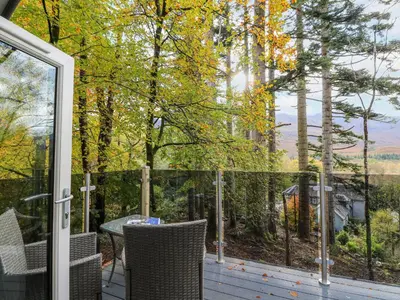 a screened in porch with a table and chairs at Elleric Pods - The Last Resort in Appin