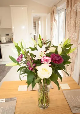 a vase filled with flowers sitting on a table at Strathearn Lodge in Auchterarder