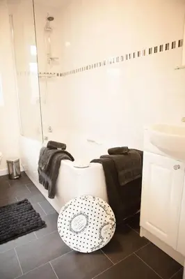 a bathroom with a toilet and a sink and a tub at Strathearn Lodge in Auchterarder