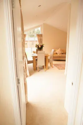 a living room with a table and a couch at Strathearn Lodge in Auchterarder