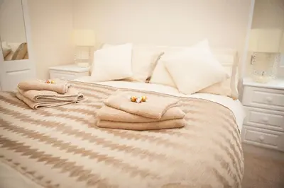 a bedroom with a bed with towels on it at Strathearn Lodge in Auchterarder