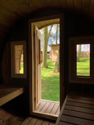 an open door in a log cabin with a window at North Lodge Glamping in Carnwath