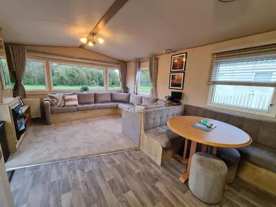 a living room with a couch and a table at 5 lochview in Beattock