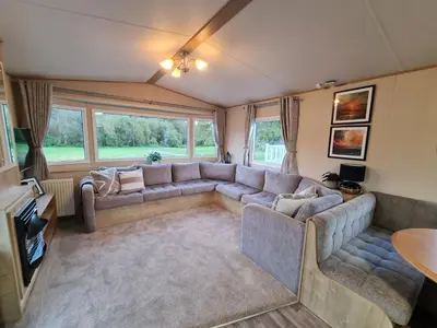 a living room with a couch and a tv at 5 lochview in Beattock