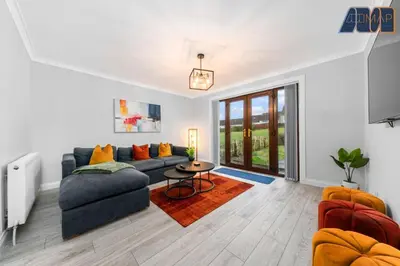 a living room with a couch and a table at Cosy 2-Bed House I Easy Edinburgh Access I Sleeps 4 in Whitburn