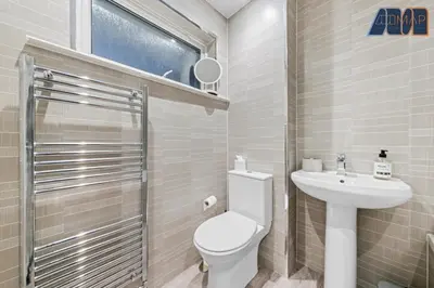 a small bathroom with a toilet and a sink at Cosy 2-Bed House I Easy Edinburgh Access I Sleeps 4 in Whitburn