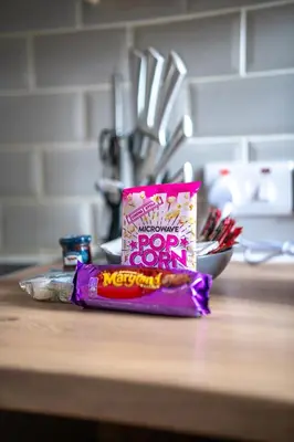 a bag of peanuts sitting on top of a counter at 2 BDR House By Caledonia Luxe Stays Short Lets & Serviced Accommodation Bathgate in Bathgate