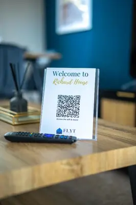 a welcome sign on a table with a remote control at 2 BDR House By Caledonia Luxe Stays Short Lets & Serviced Accommodation Bathgate in Bathgate
