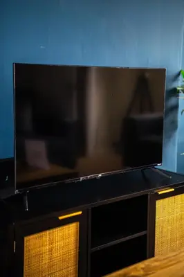 a flat screen tv sitting on top of a cabinet at 2 BDR House By Caledonia Luxe Stays Short Lets & Serviced Accommodation Bathgate in Bathgate