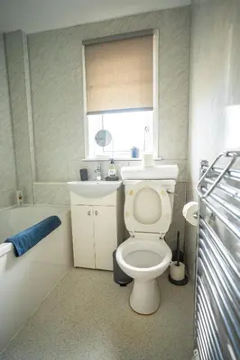a bathroom with a toilet and a sink and a tub at 2 BDR House By Caledonia Luxe Stays Short Lets & Serviced Accommodation Bathgate in Bathgate