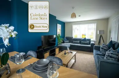 a living room with a couch and a table at 2 BDR House By Caledonia Luxe Stays Short Lets & Serviced Accommodation Bathgate in Bathgate