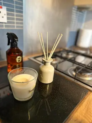 a counter top with a glass of milk and bamboo sticks at Modern Economy Glasgow Apartment with King bed in Glasgow