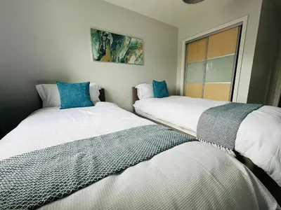 two beds sitting next to each other in a room at Modern Economy Glasgow Apartment with King bed in Glasgow